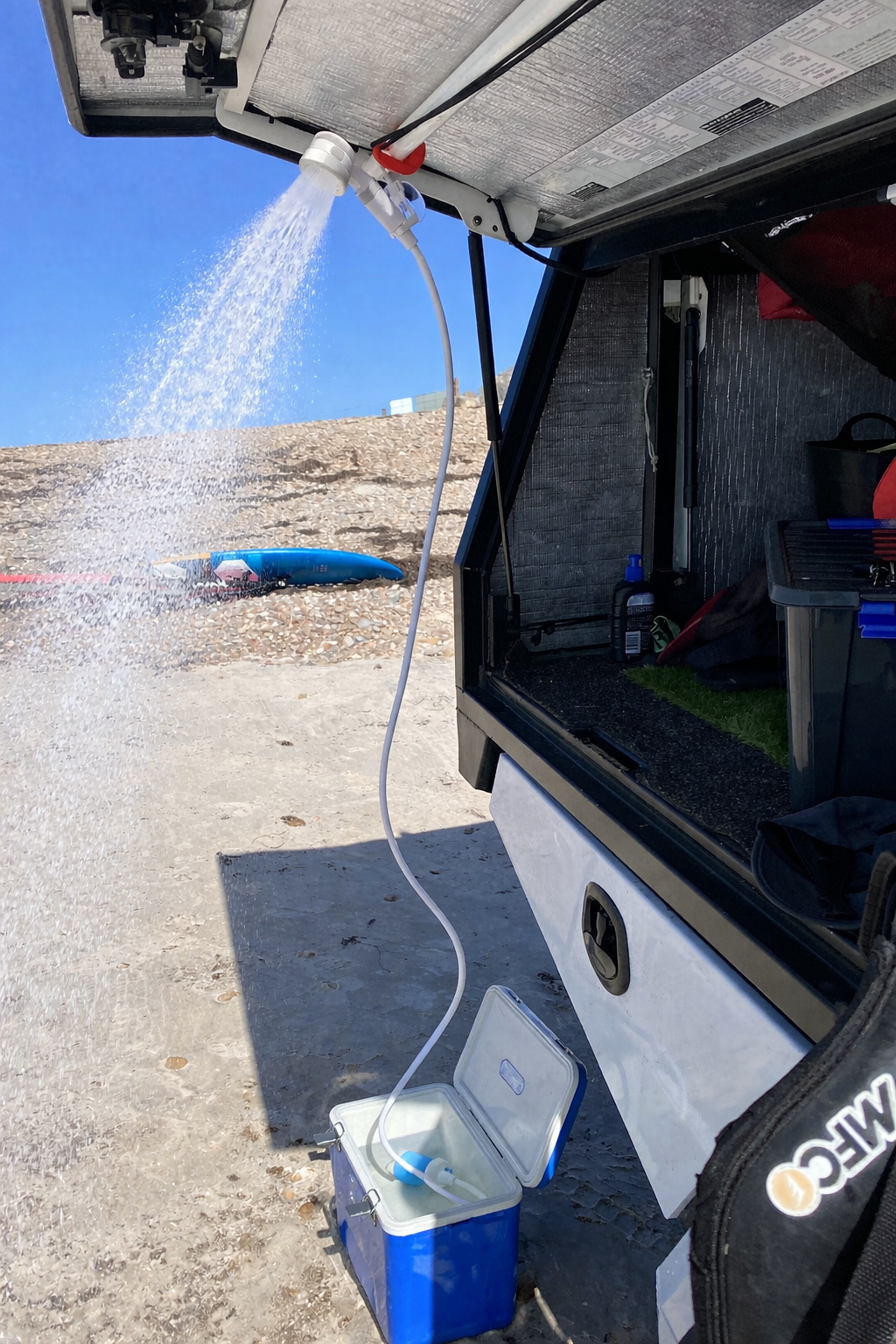Portable shower being used near the beach