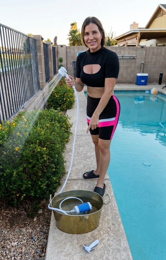 Portable shower being used beside a swimming pool