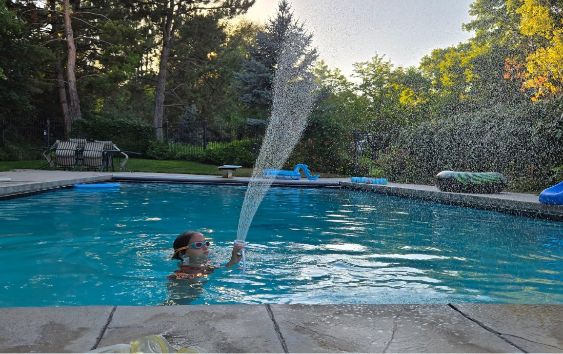 Portable shower being used outdoors with the family